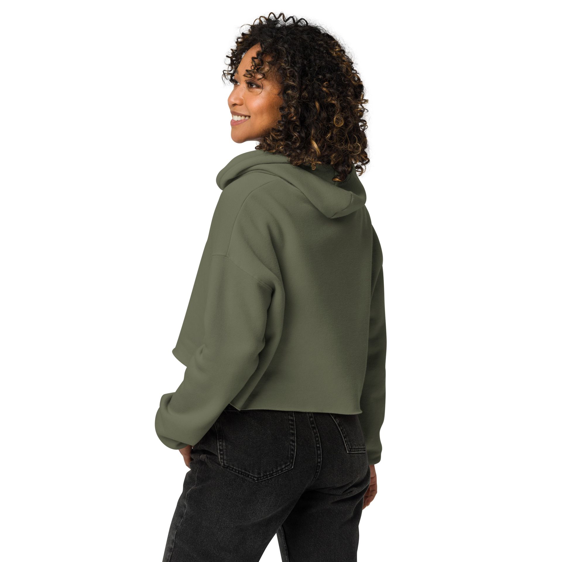 A woman is wearing a green hoodie and black jeans