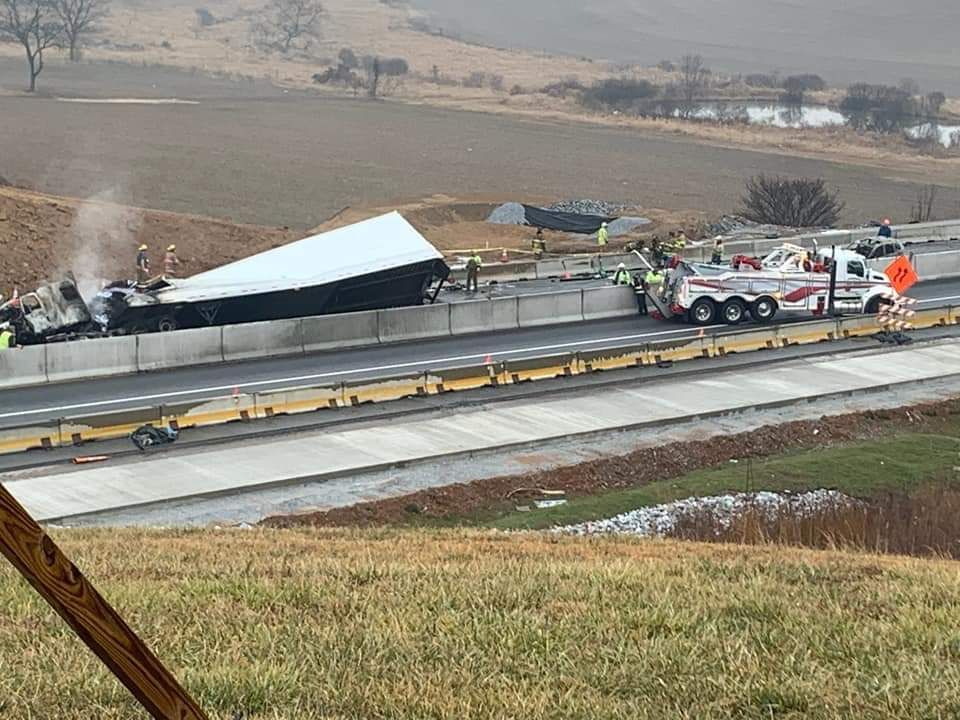 A semi truck has fallen off the side of a highway.