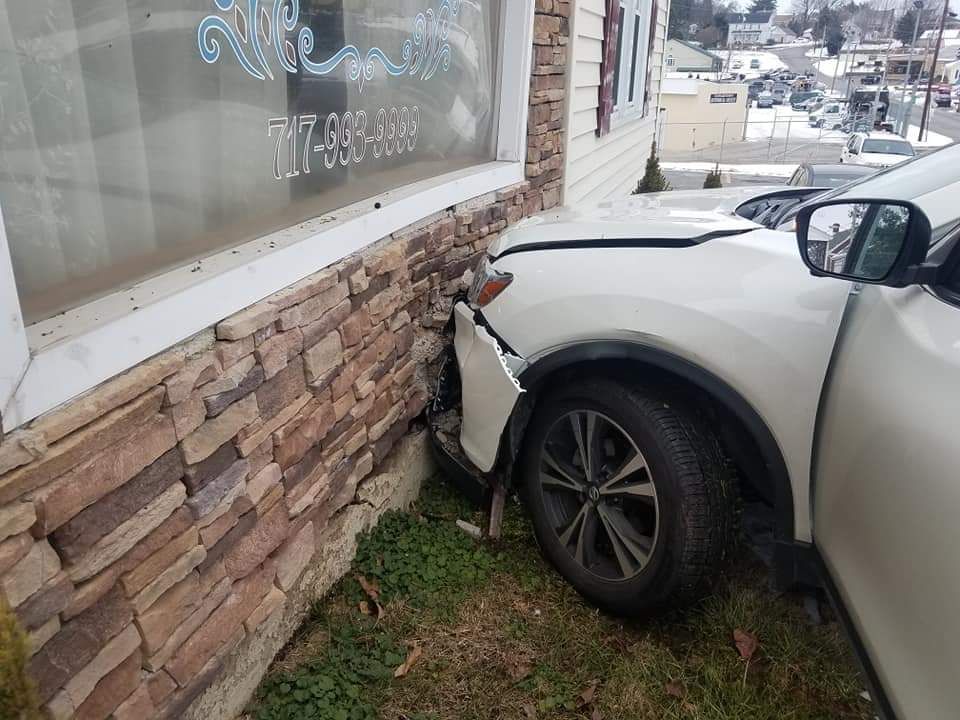 A car has crashed into the side of a building.