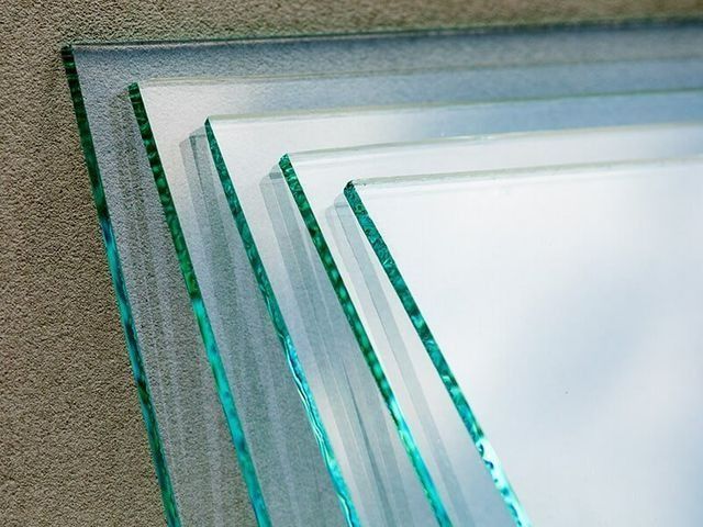Several Pieces of Glass Are Stacked on Top of Each Other — Southside Glass & Aluminium In Bentley Park, QLD 