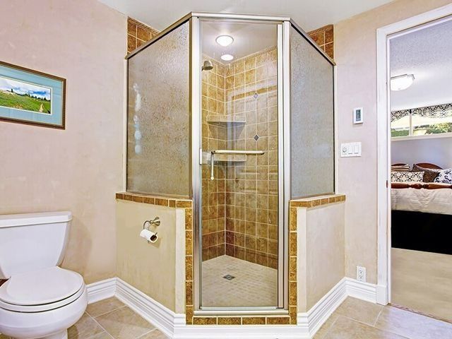 A Bathroom With a Toilet and a Walk in Shower — Southside Glass & Aluminium In Bentley Park, QLD