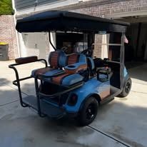 Blue and black golf cart parked in a driveway, with a canopy and four seats.