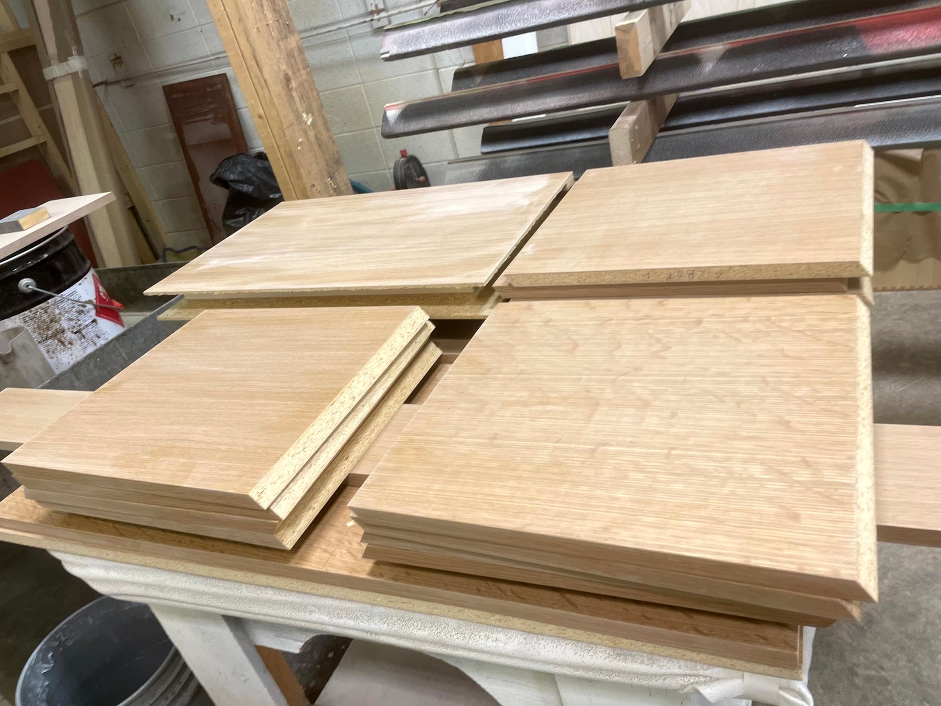 A bunch of wooden boards are stacked on top of each other on a table.