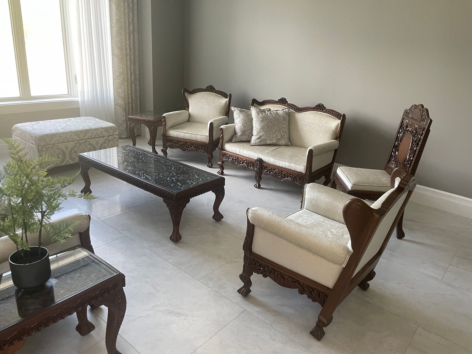 A living room with a couch , chairs and a coffee table