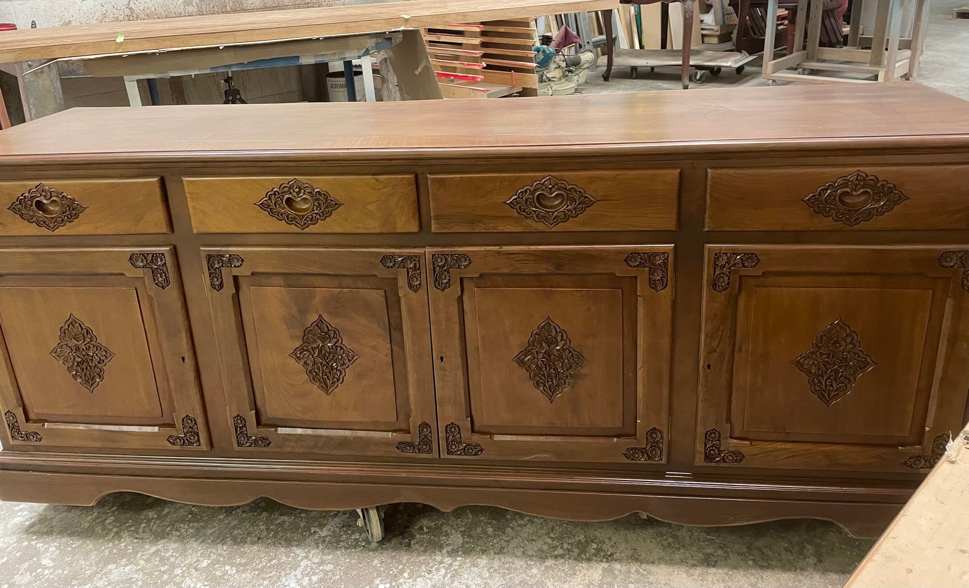 A wooden dresser with drawers and doors in a room