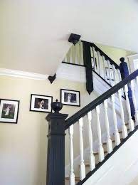 A staircase with a black railing and white steps in a house.