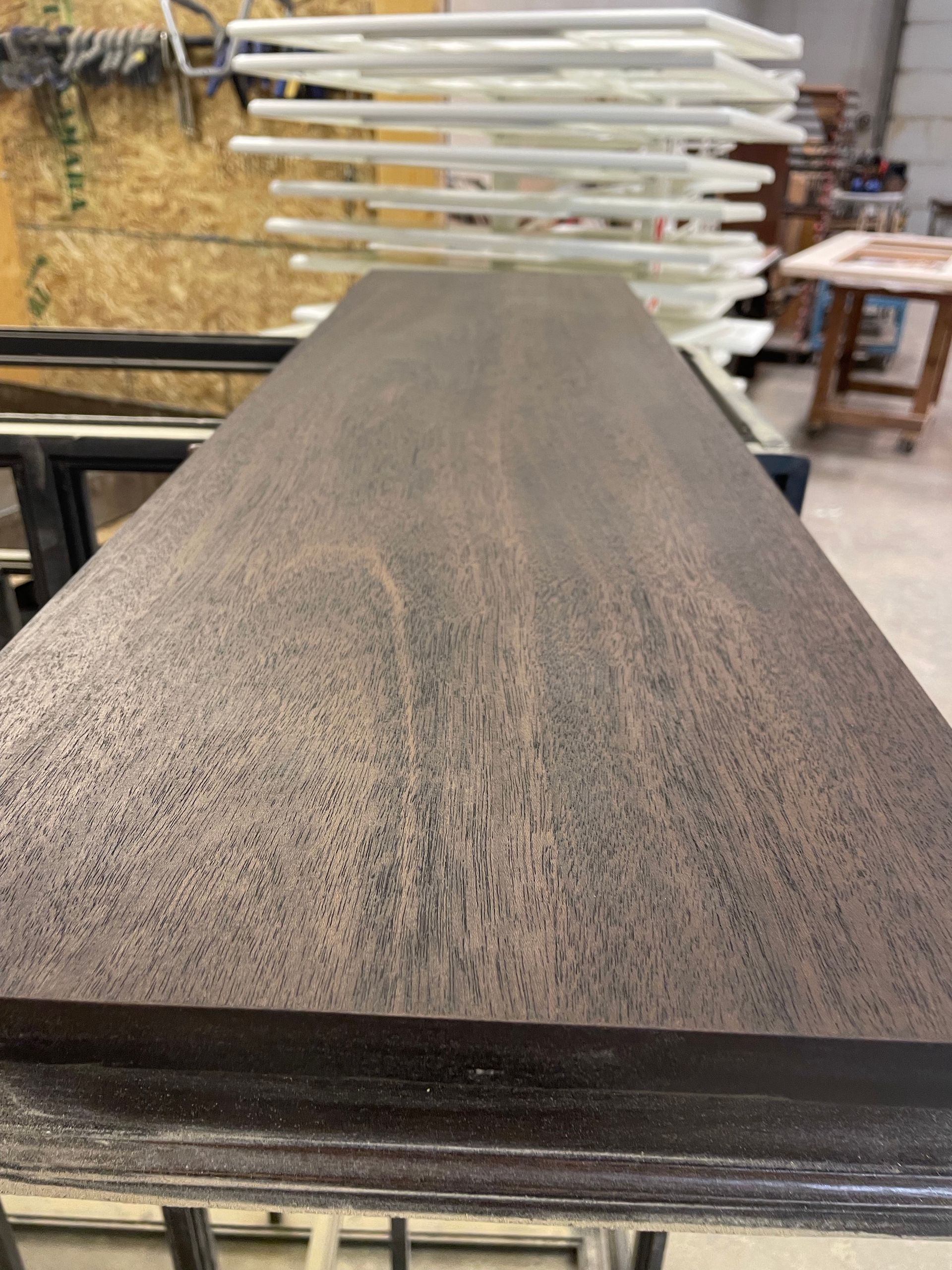 A piece of wood is sitting on top of a table in a room.
