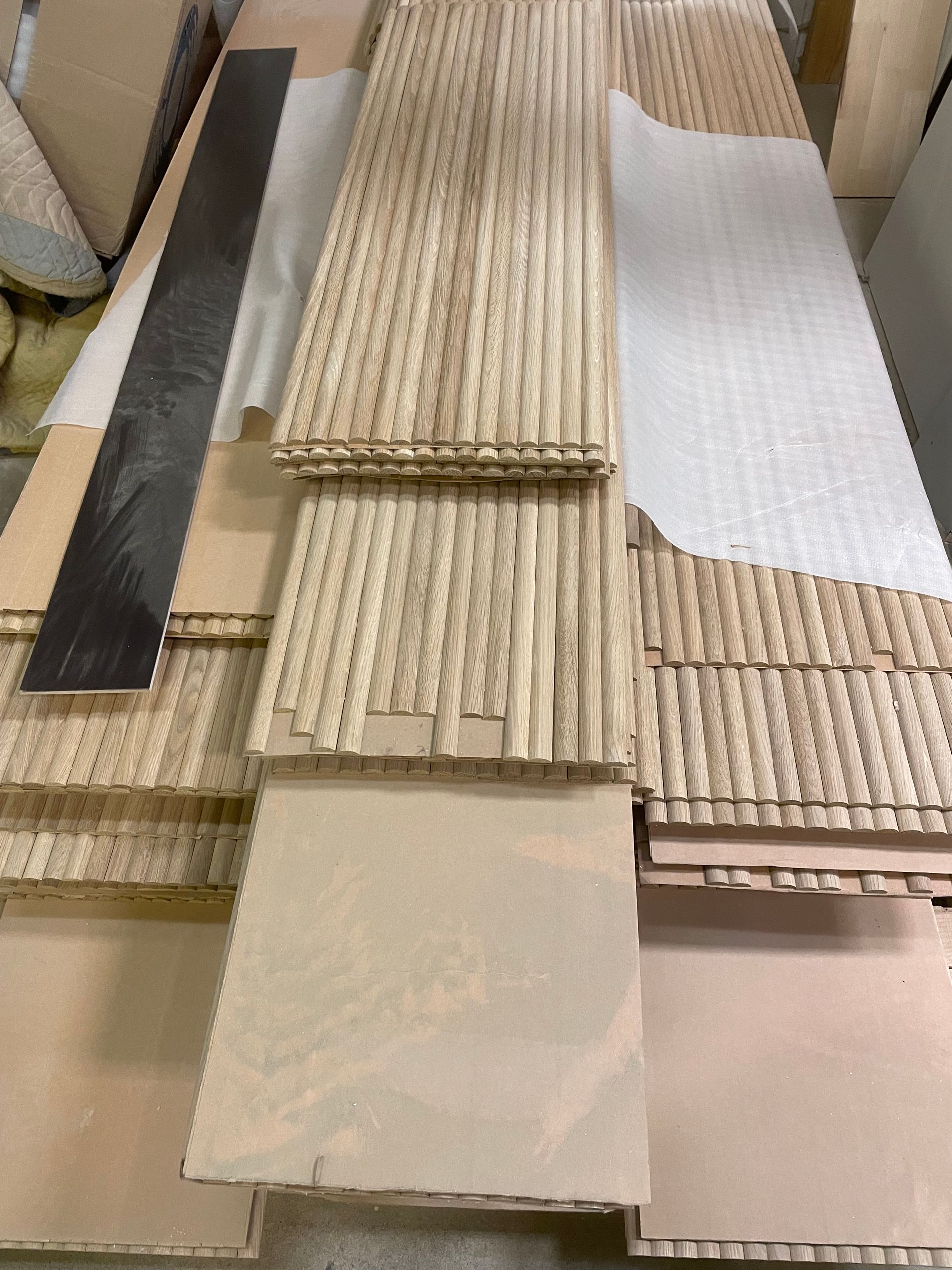 A bunch of wooden boards are stacked on top of each other on a table.