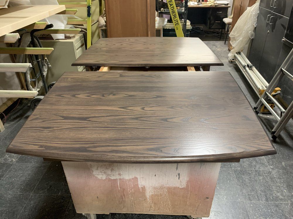 A wooden table is sitting on a cart in a workshop.