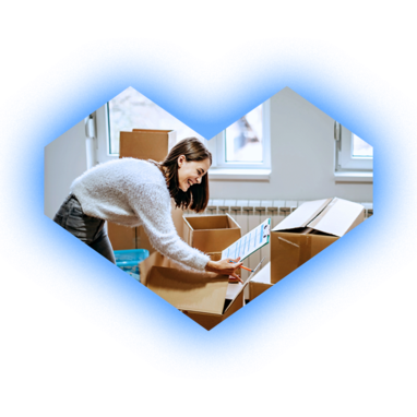 Woman packing boxes in a room, smiling, with a clipboard, inside a blue heart outline.