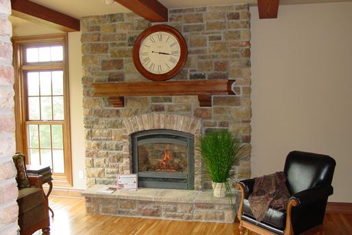 A living room with a fireplace and a clock above it