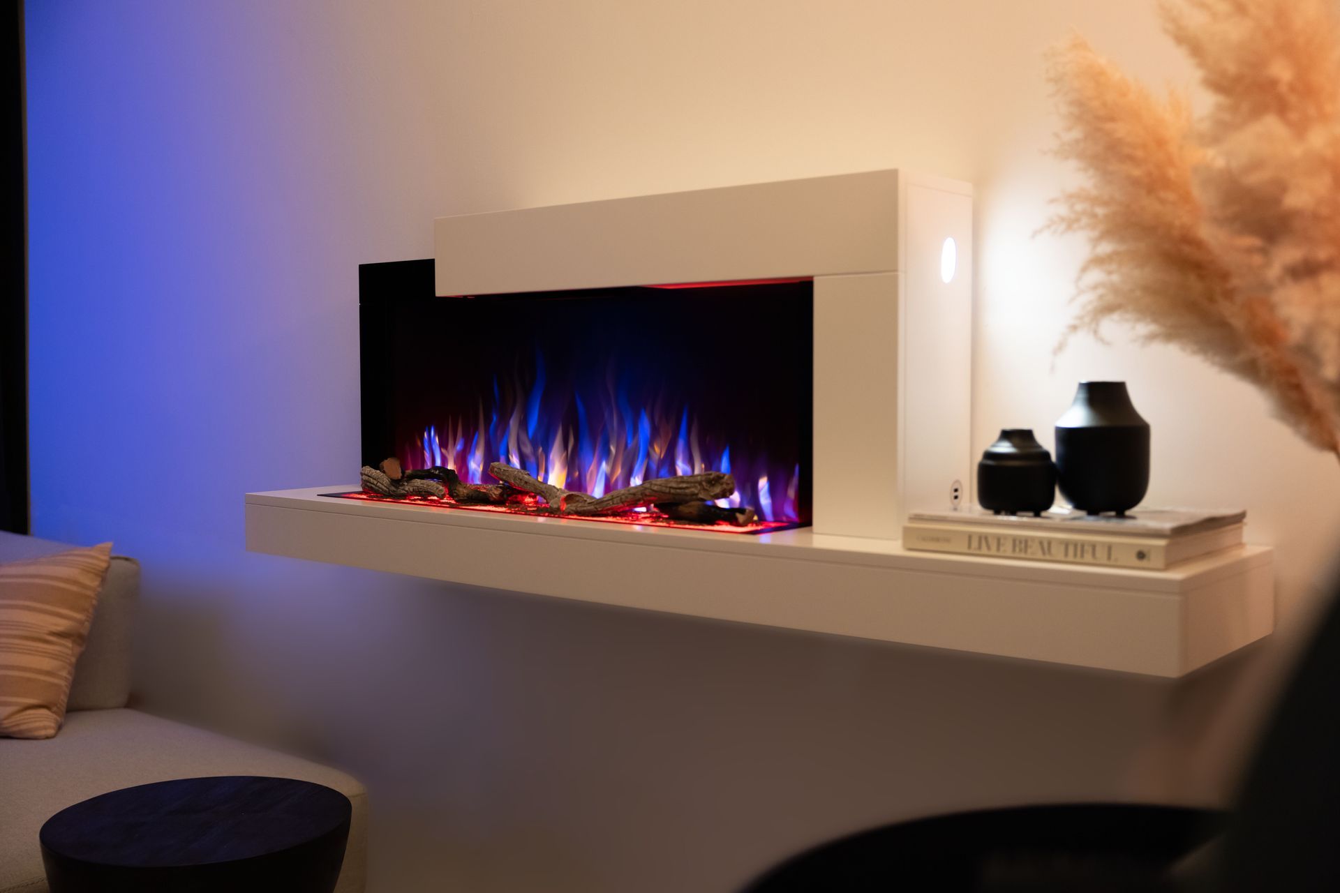 A fireplace is hanging on a wall above a wooden table.