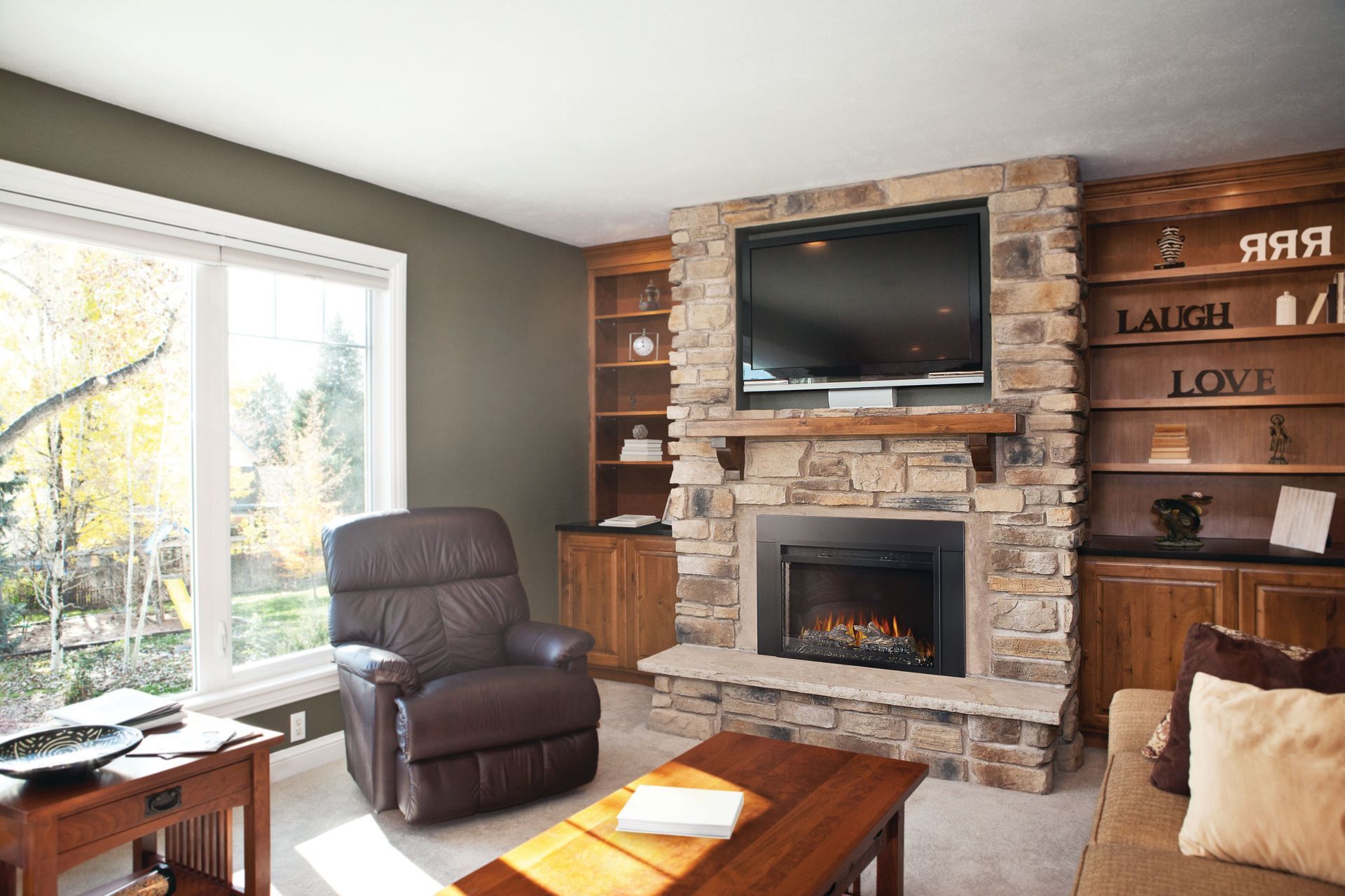 A living room with a fireplace and a tv stand