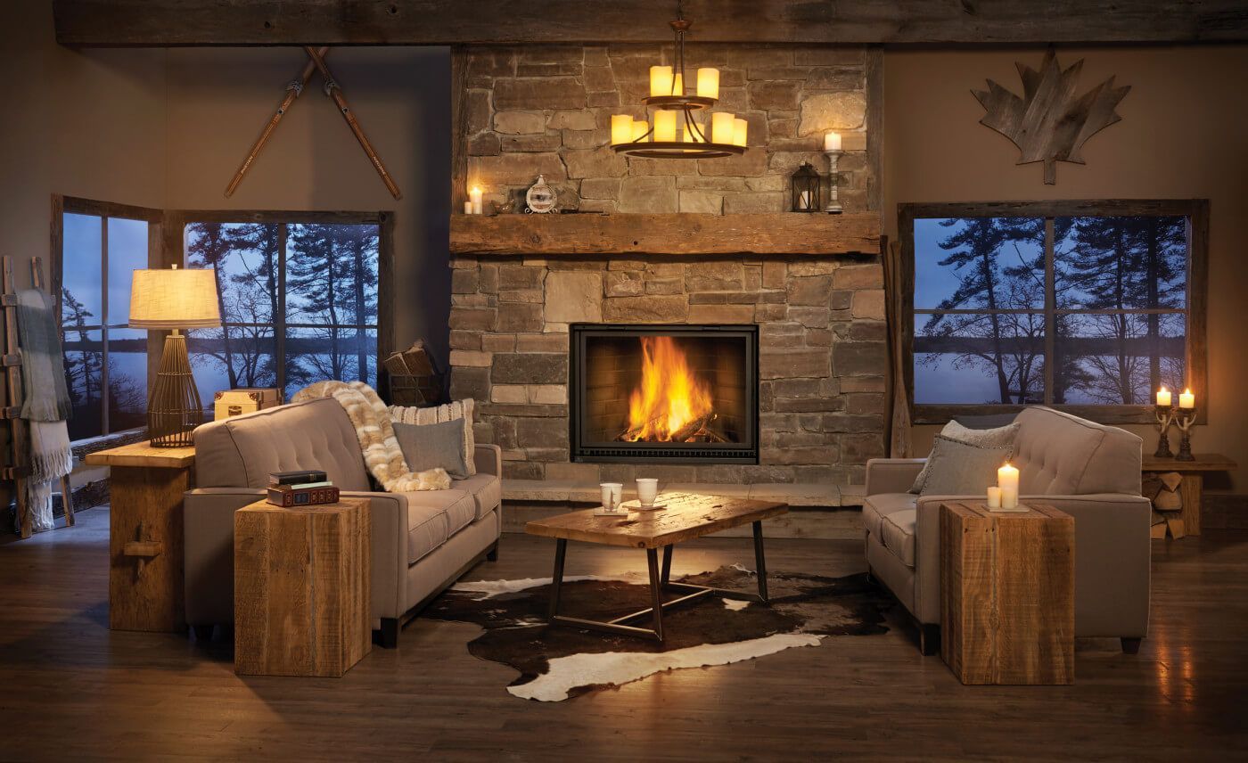 A living room with a fireplace and two candles