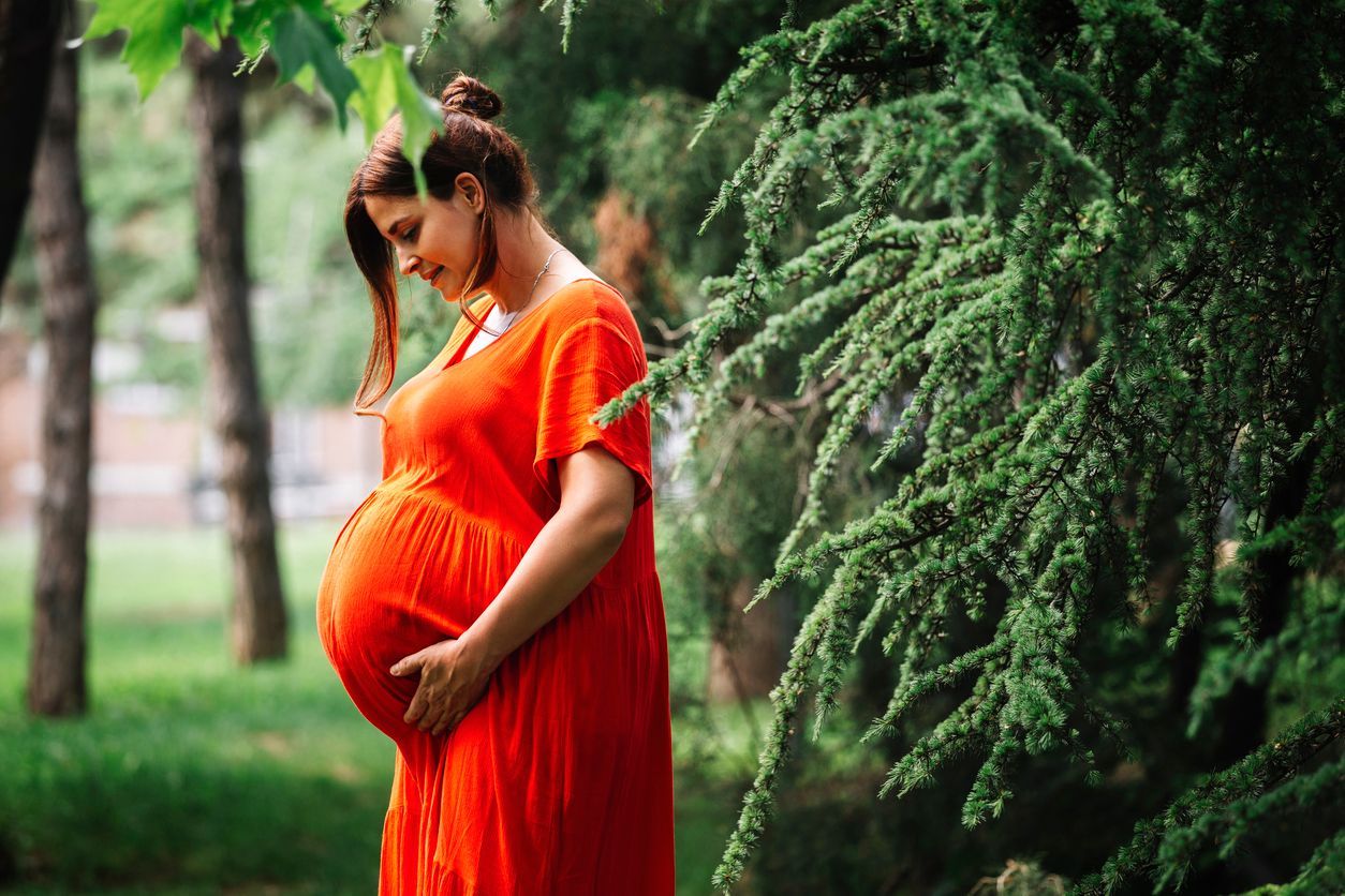 Pregnant woman cradling her belly