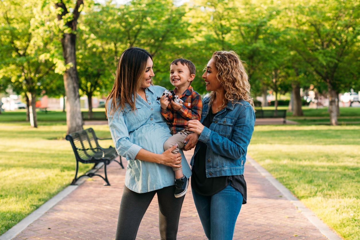 Two women holding a child