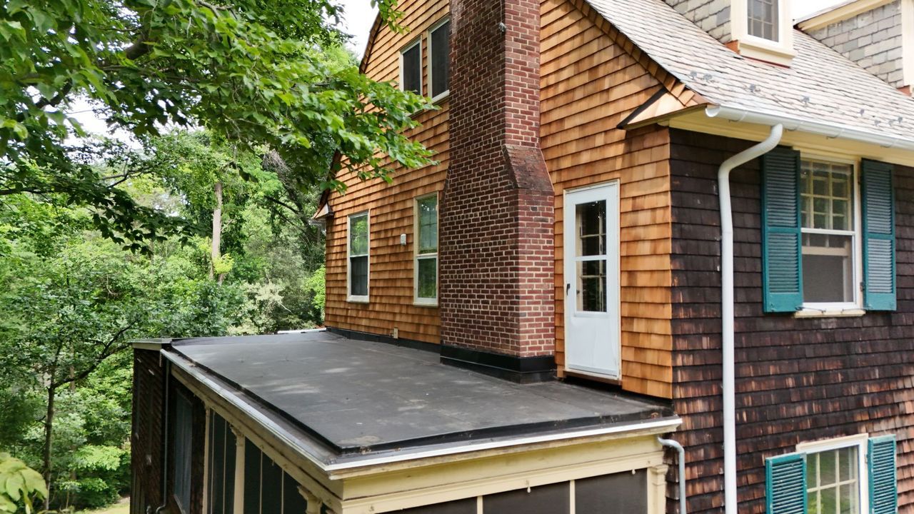 Flat porch roof on a shingle-sided Baltimore-area home