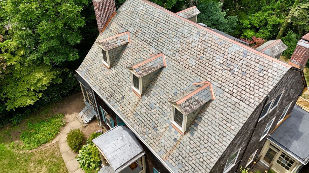 Slate roof with copper flashing on a Roland Park home, seen from a drone