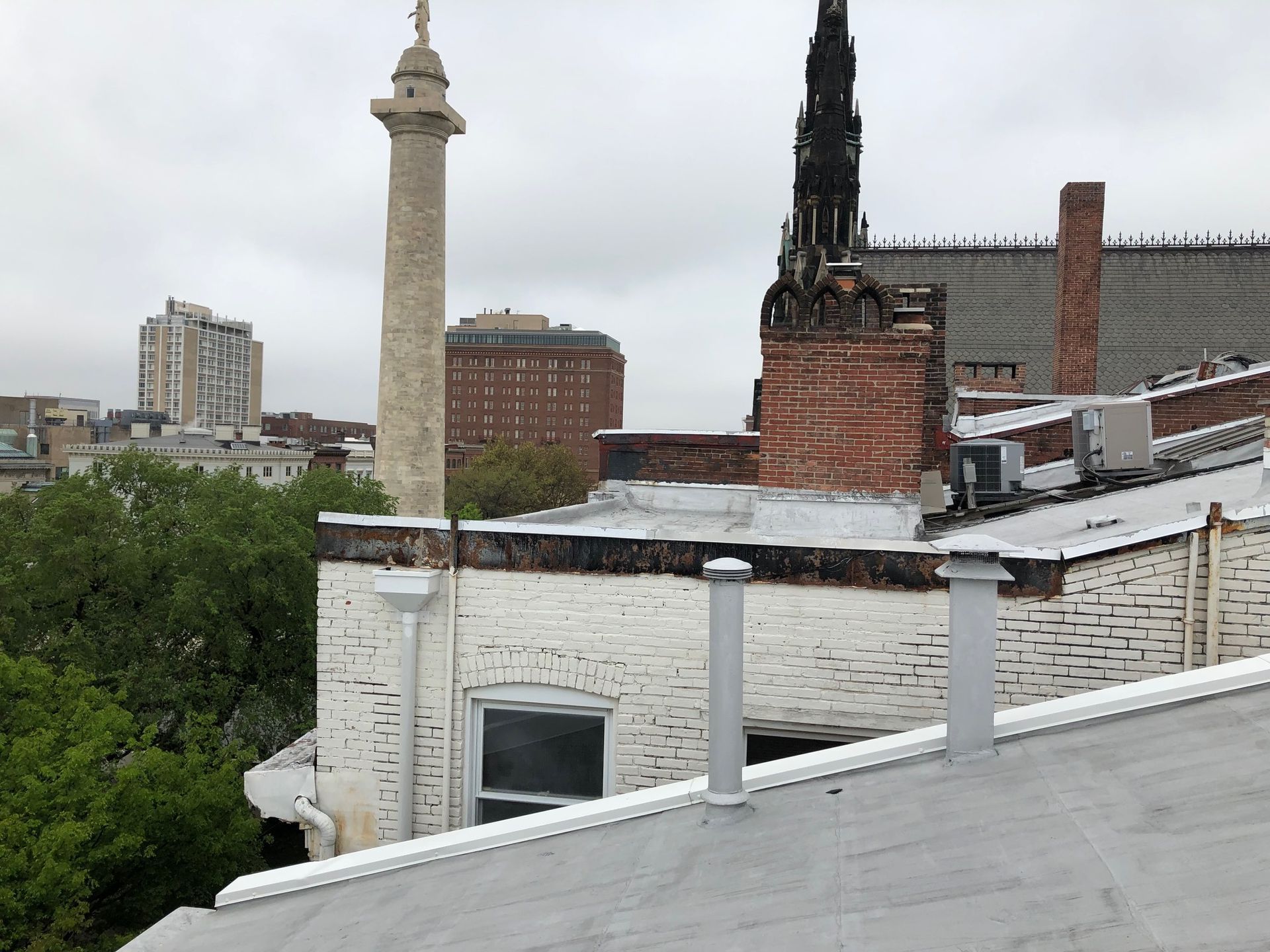 A view of a city from the roof of a building service area for omni-roof.com