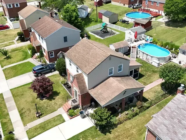 Drone photo looking down on houses and roofs in a Baltimore-area neighborhood