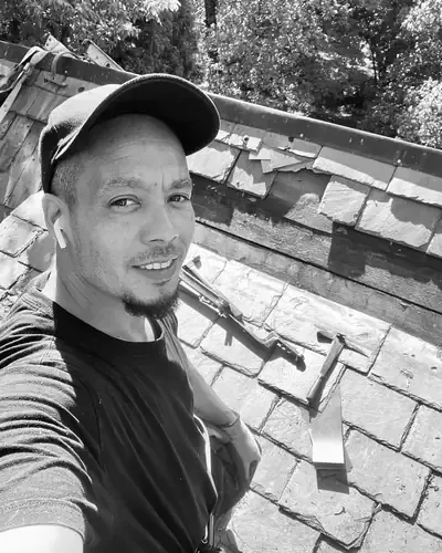James Preston, owner of Omni-Roof, up on a slate roof