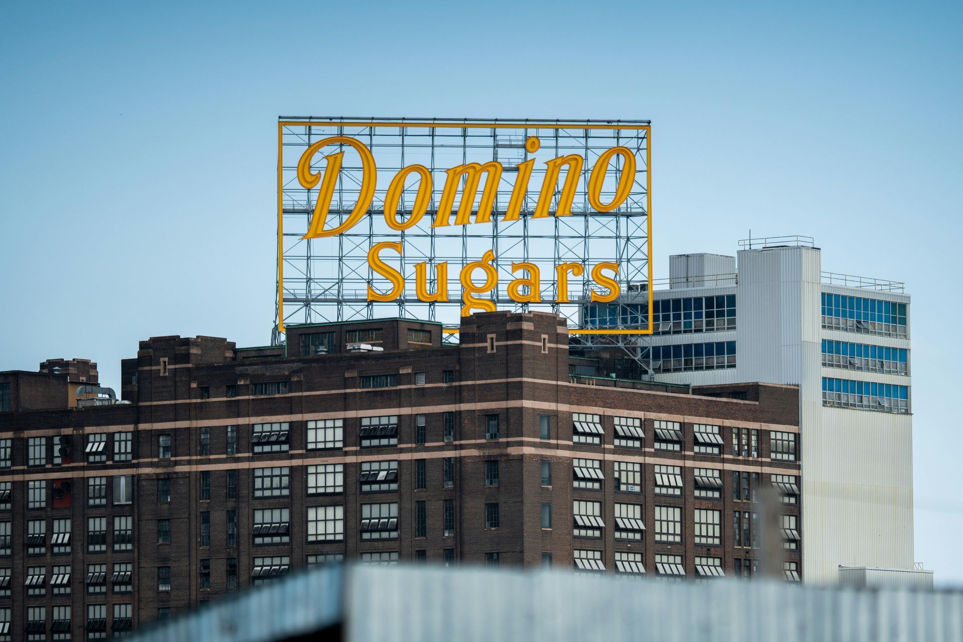 A large billboard on top of a building that says domino sugars