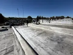 Freshly silver coated flat roofs on a row of Baltimore rowhouses