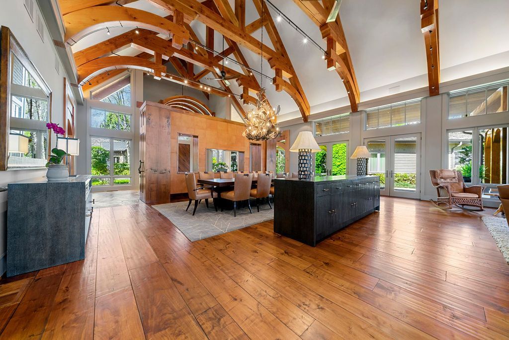 A large living room with hardwood floors and a wooden ceiling.