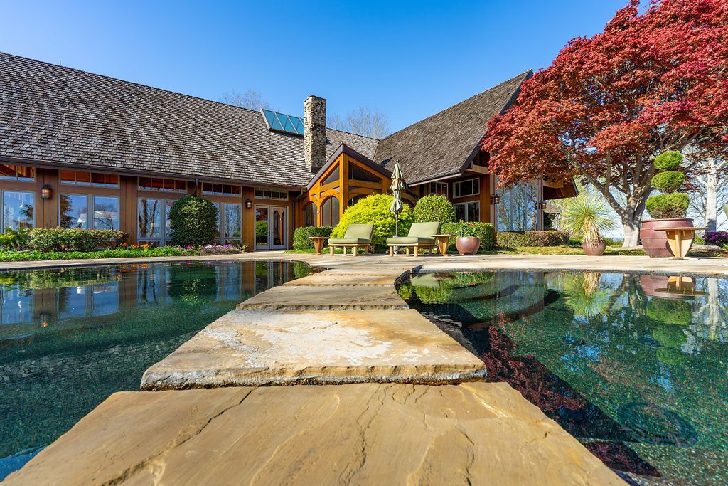 A large house with a swimming pool in front of it.