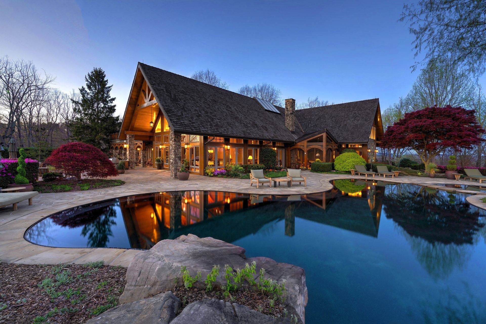 A large house with a large swimming pool in front of it