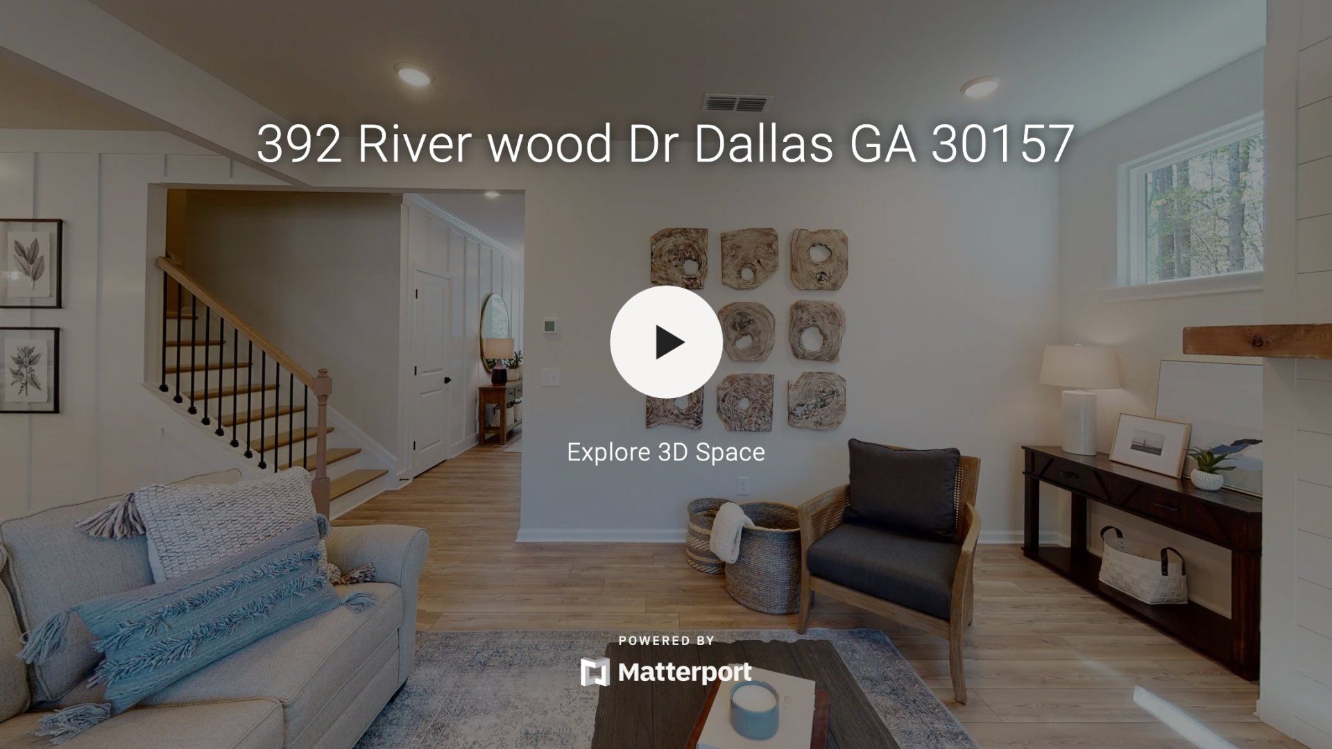 A living room with a couch , chair , table and fireplace.