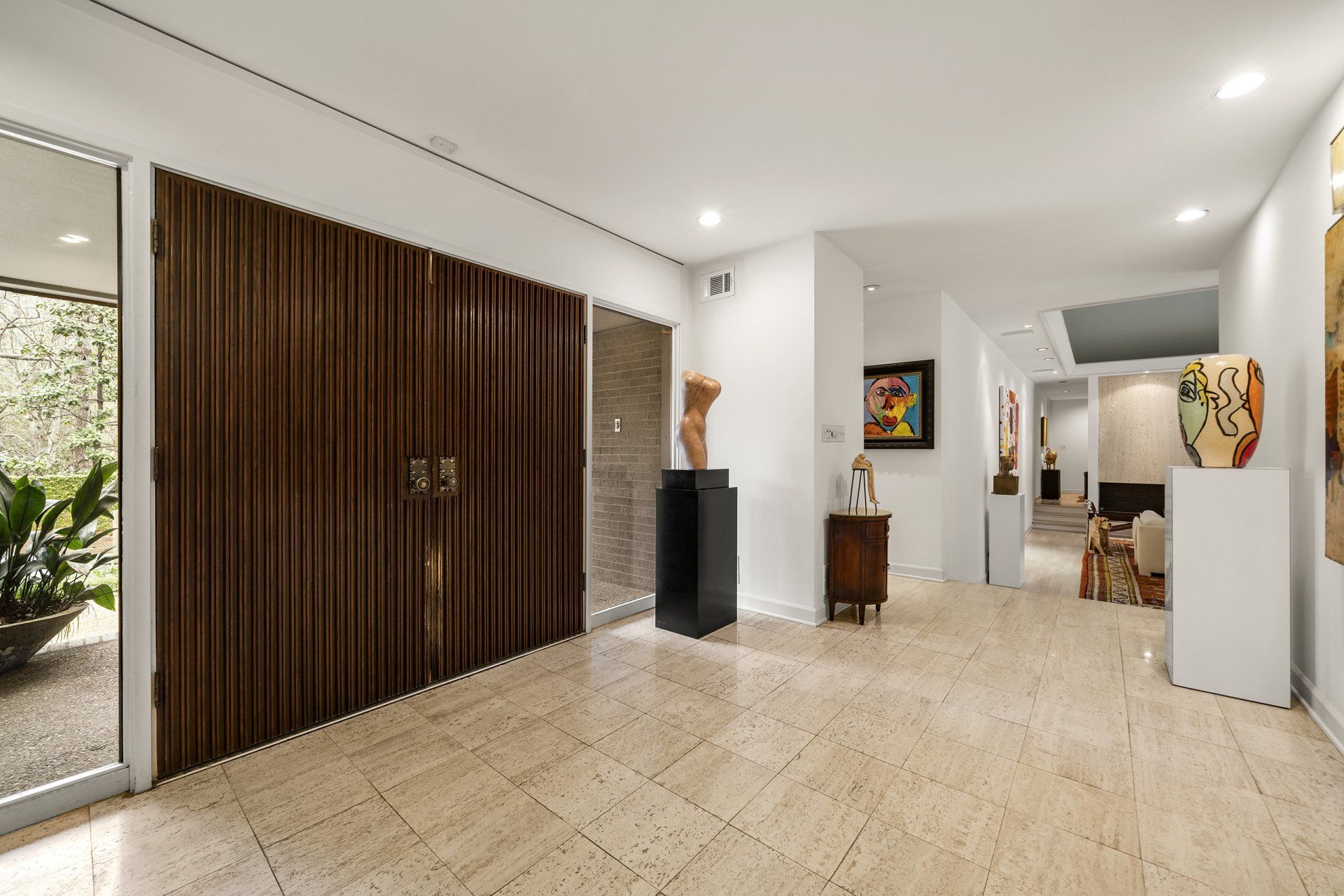 A hallway with a wooden wall and a painting on the wall