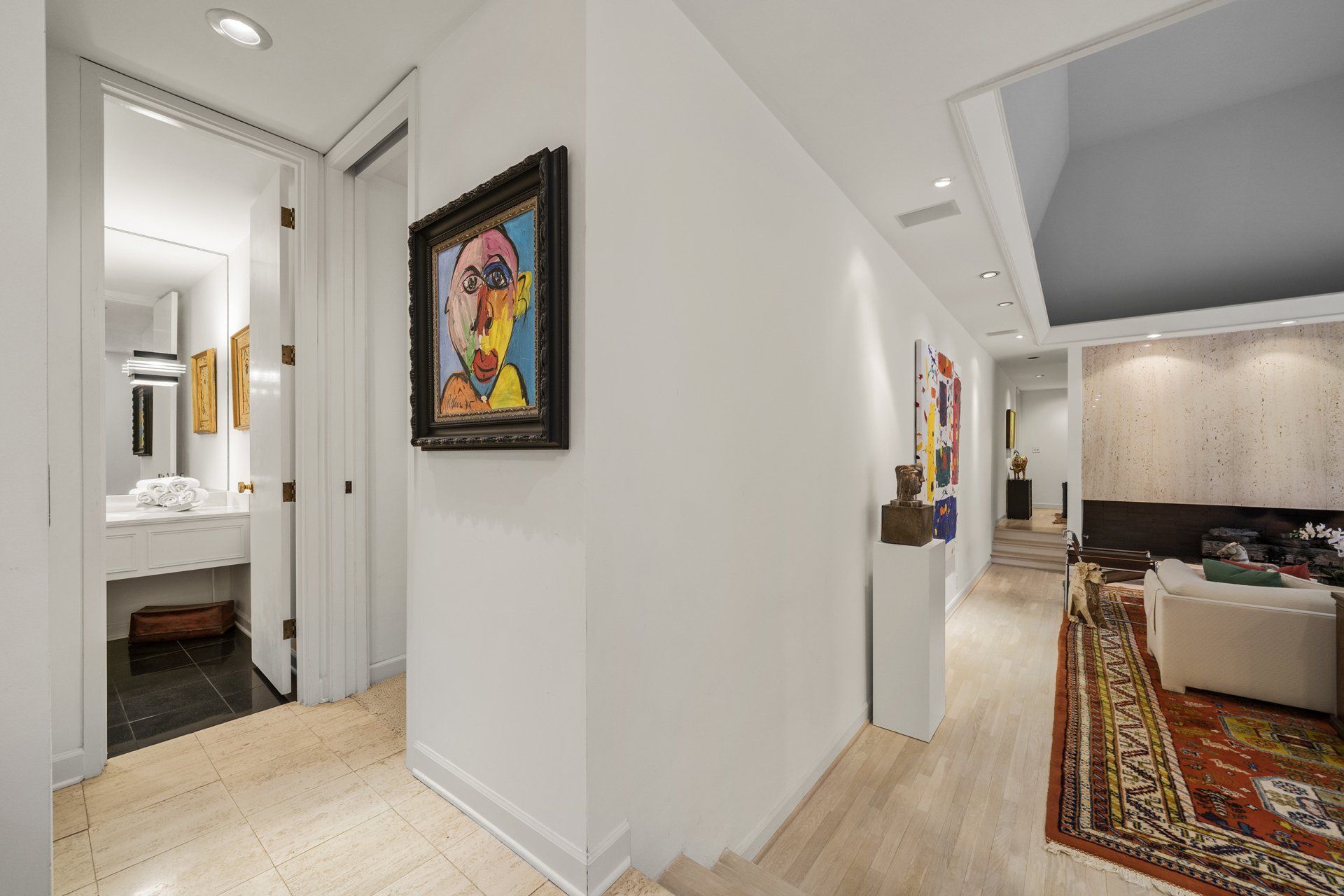 A hallway in a house with a painting on the wall.