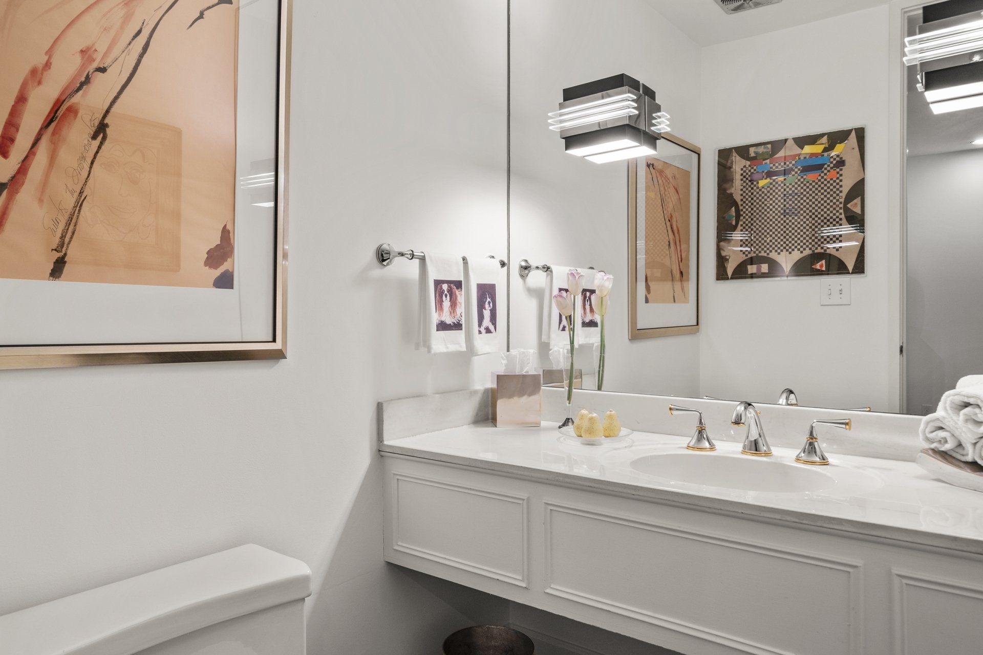A bathroom with a toilet , sink , and mirror.