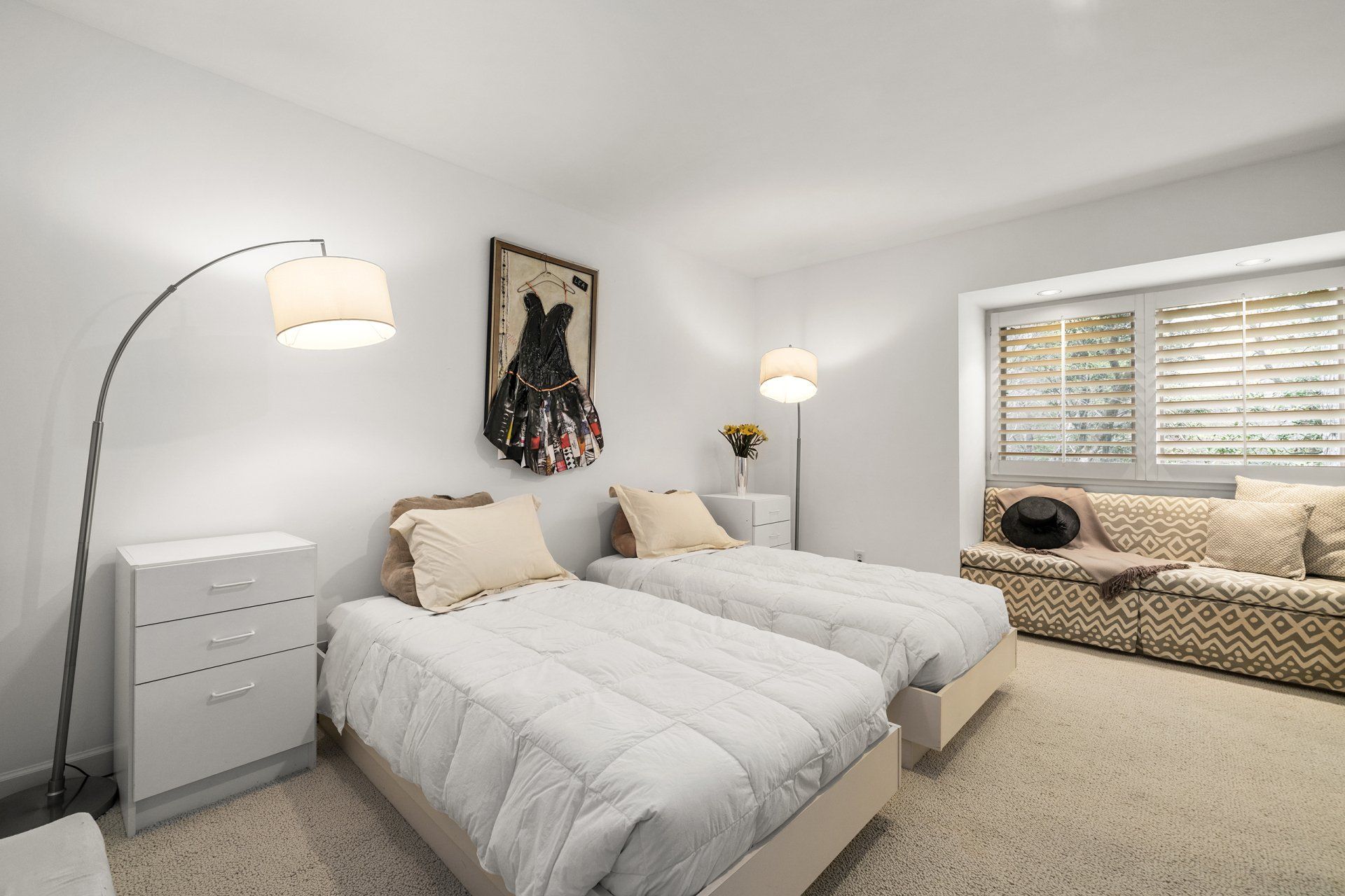 A bedroom with two twin beds and a couch