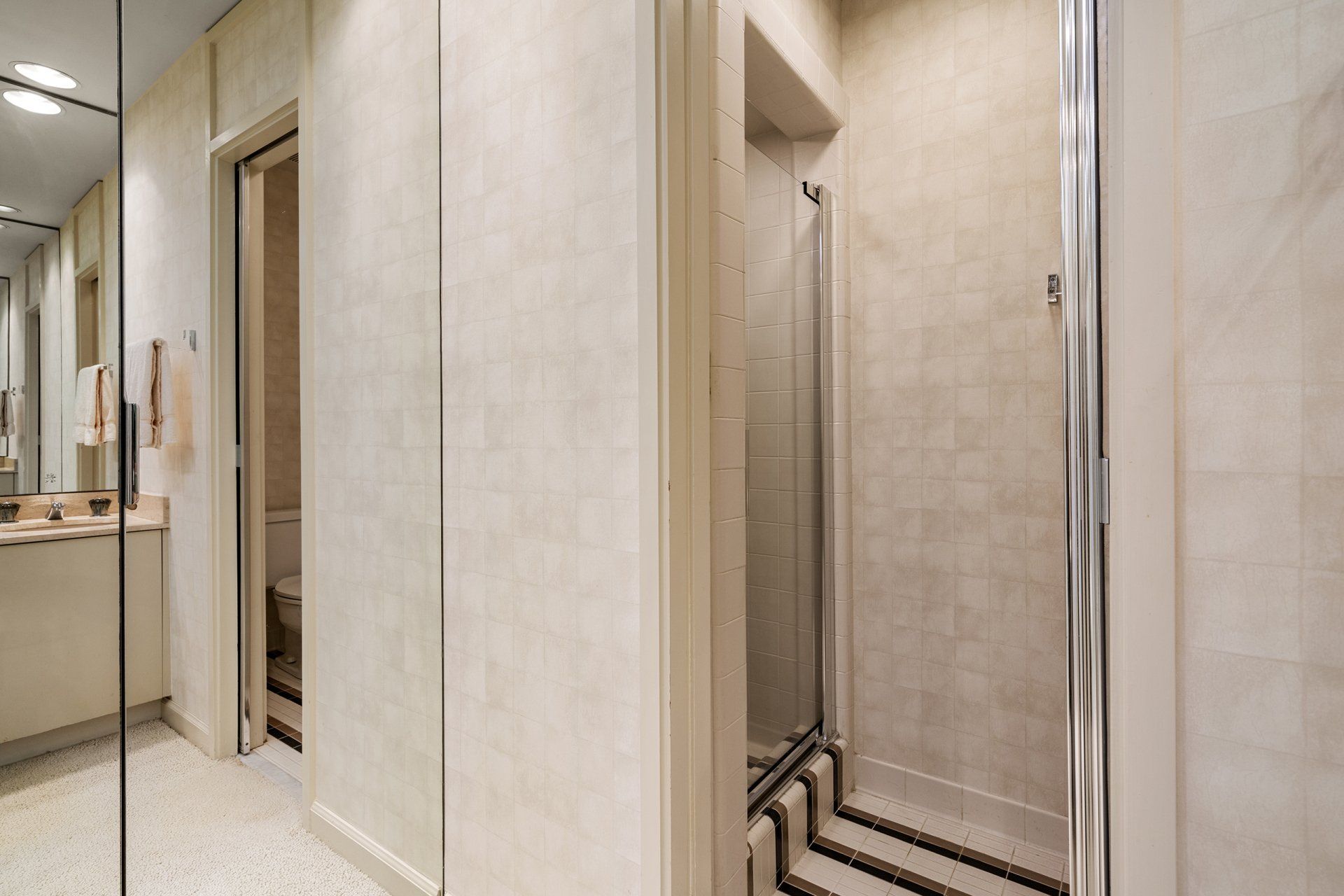 A bathroom with a walk in shower and a toilet.