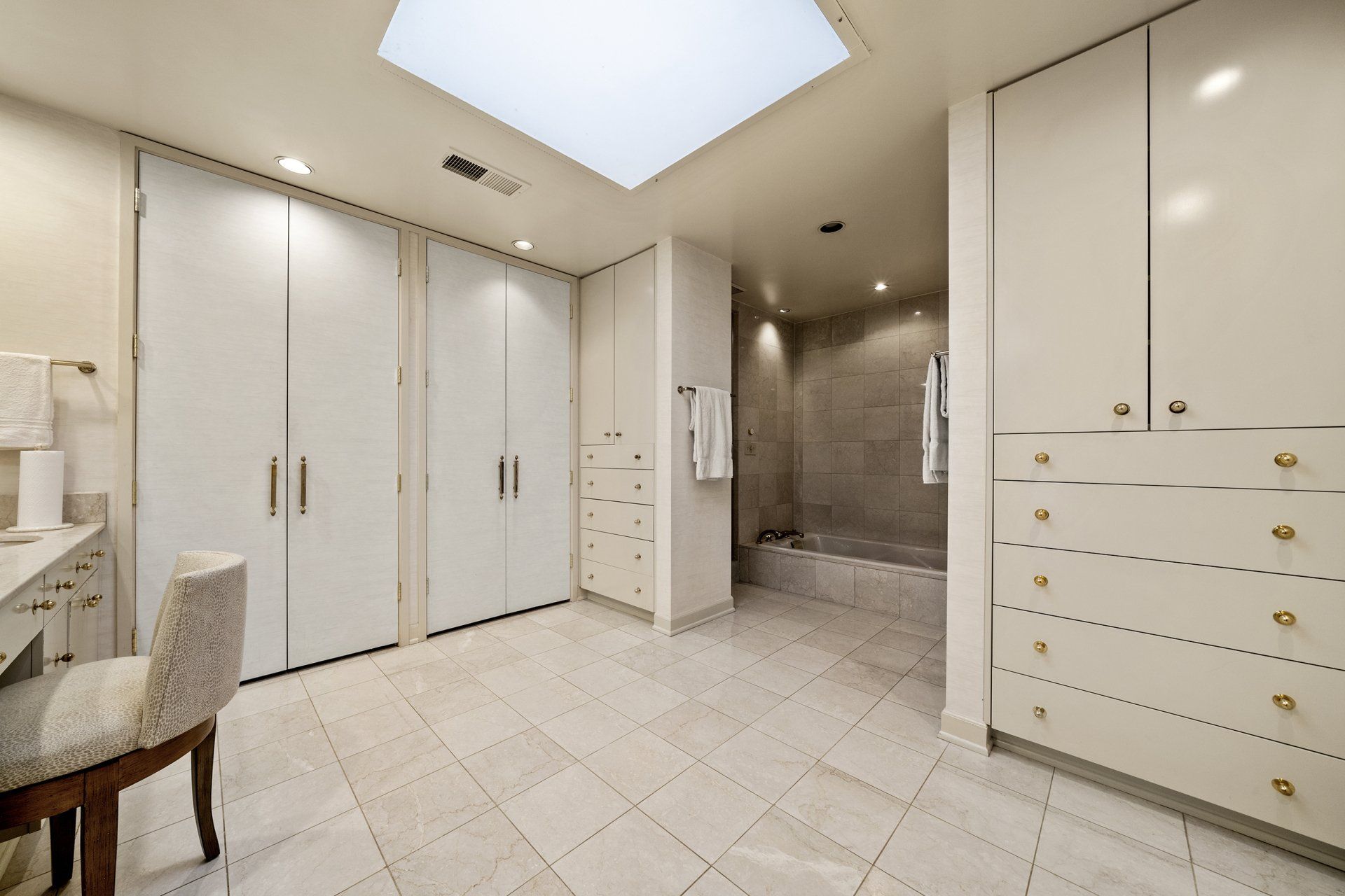 There is a skylight in the ceiling of the bathroom.