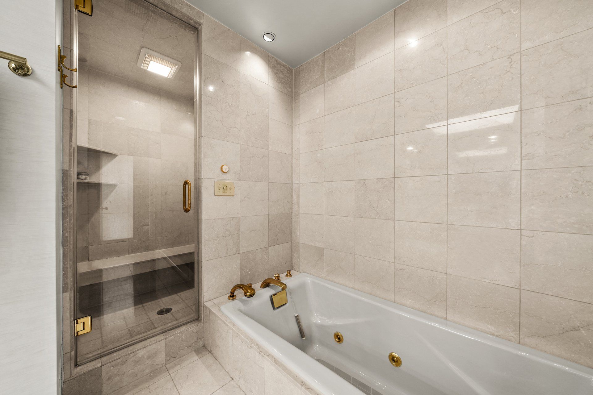 A bathroom with a bathtub and a walk in shower.