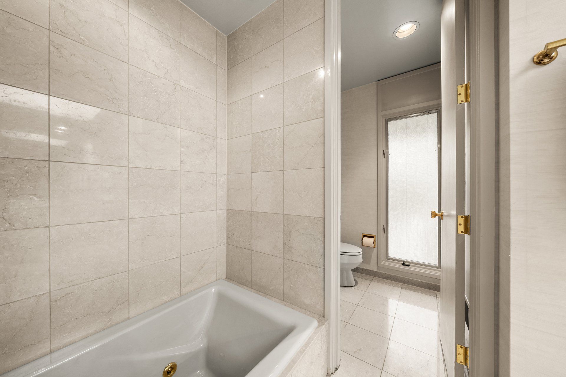 A bathroom with a bathtub and a toilet