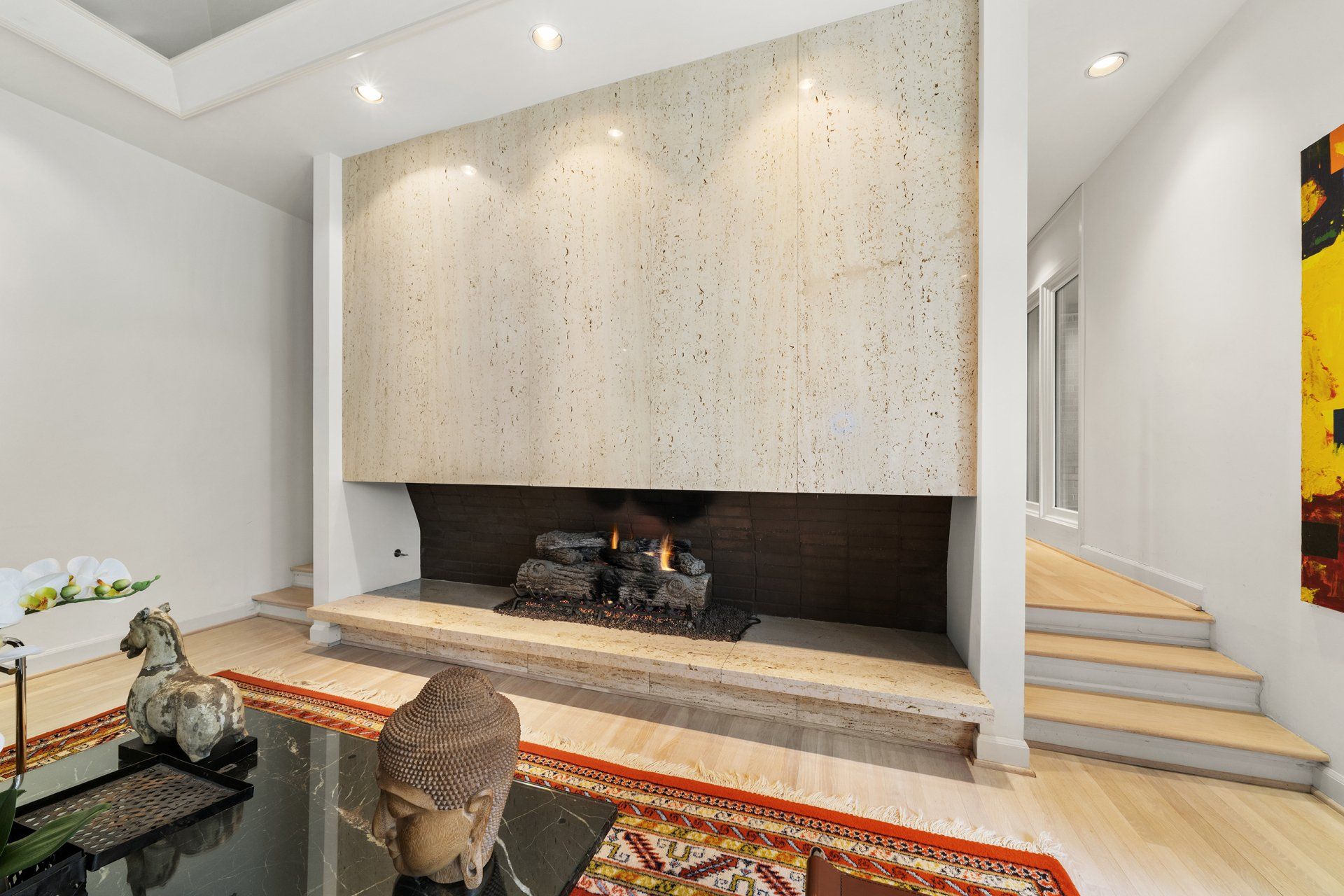 A living room with a fireplace and stairs