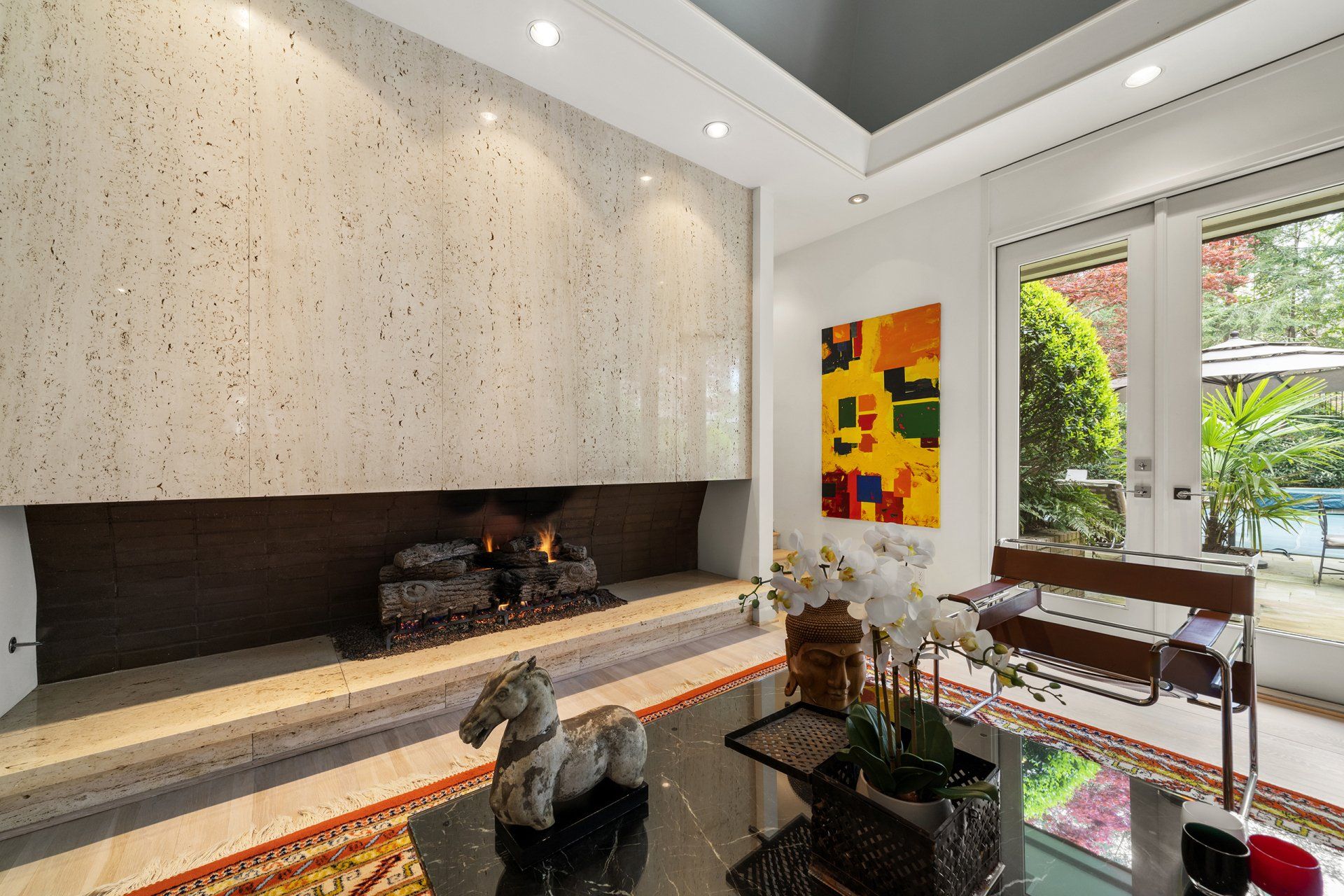 A living room with a fireplace and a table.