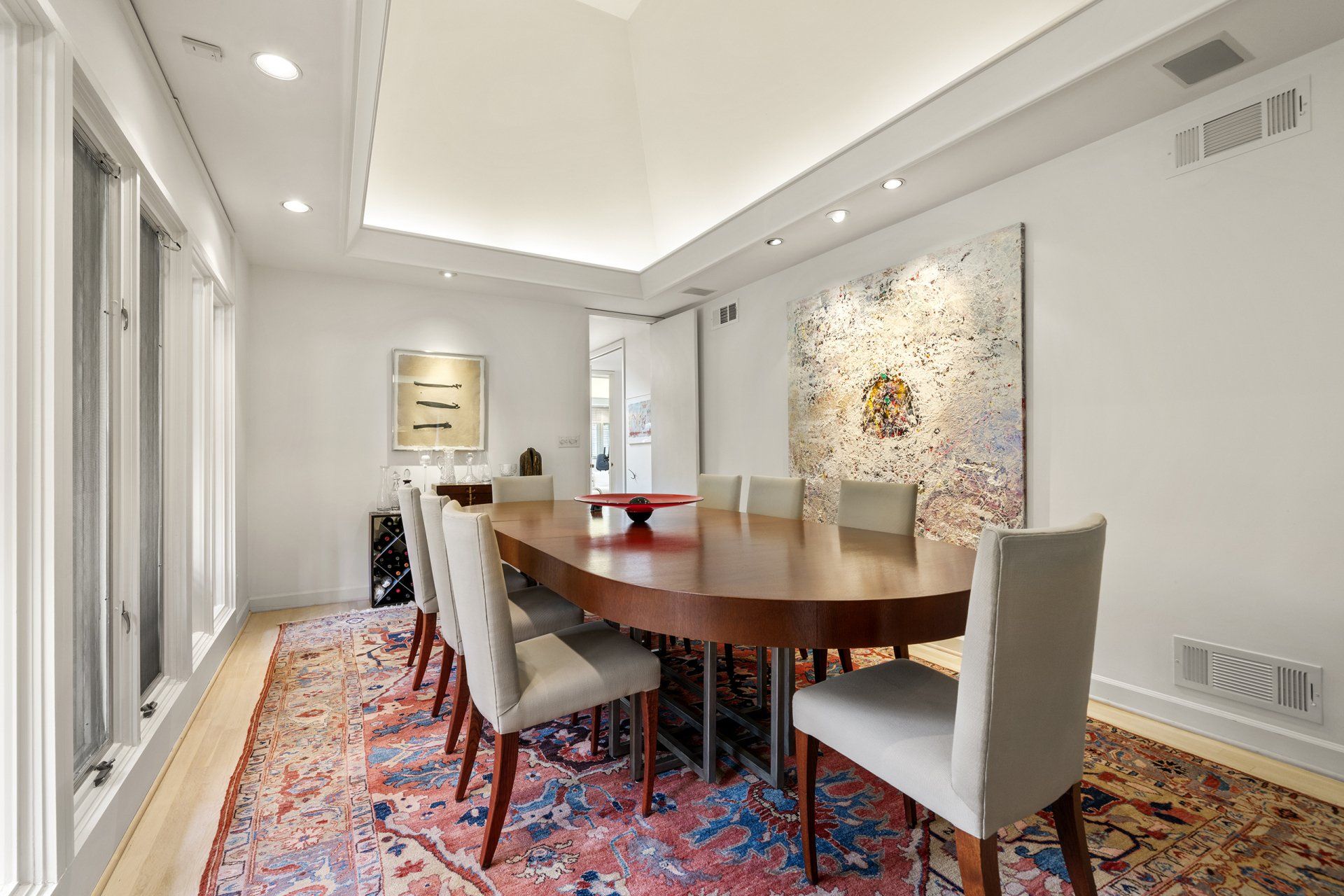 A large dining room with a long table and chairs.