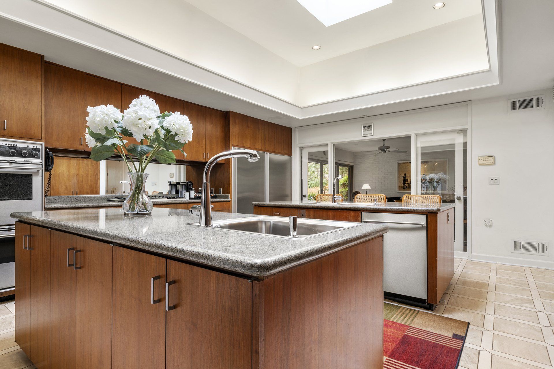 A kitchen with a large island and a sink.