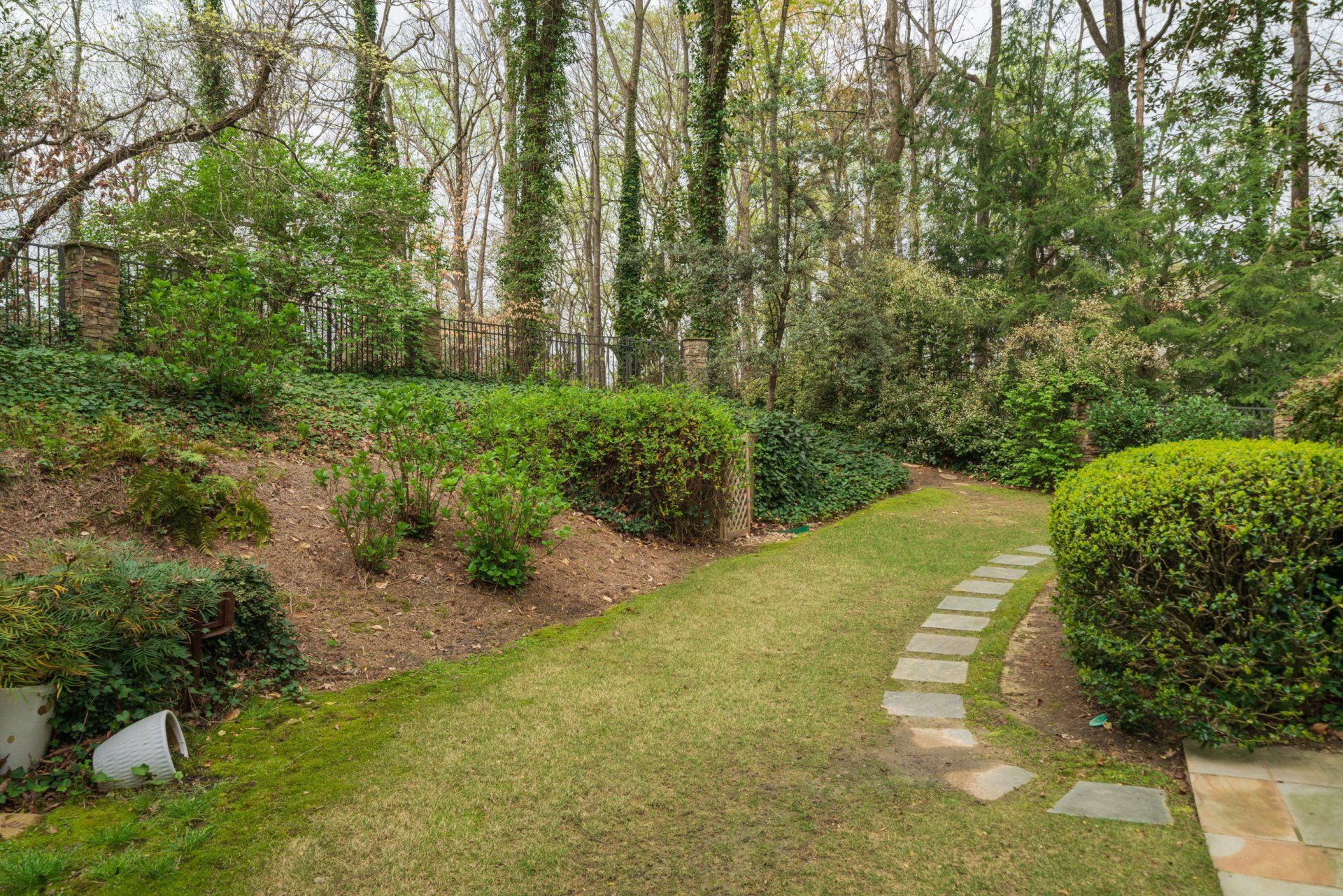 There is a path going through the grass in the middle of the garden.