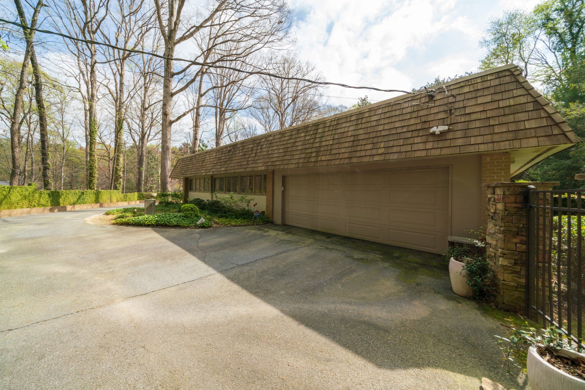 A large house with a garage and a driveway in front of it.