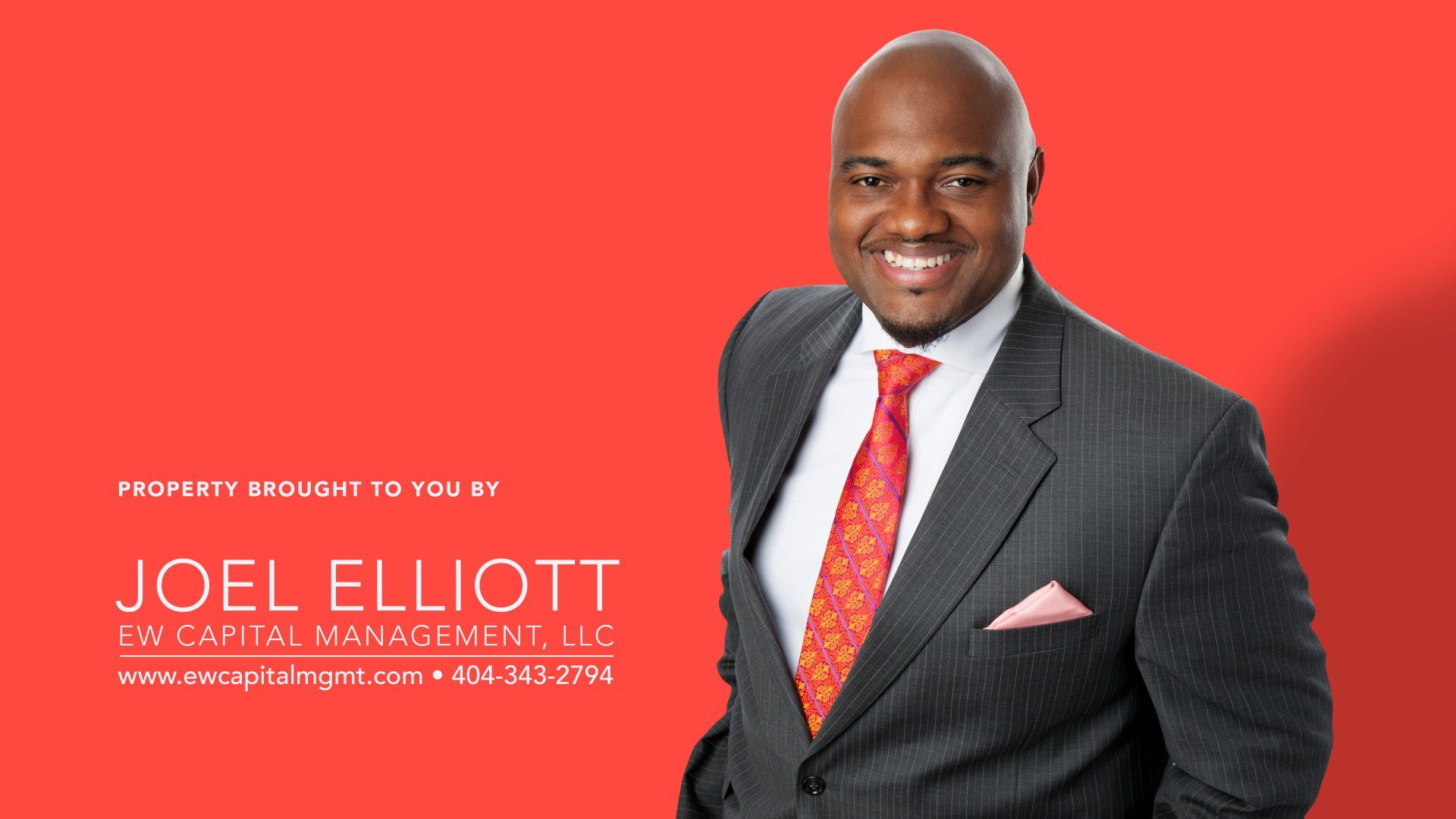 Smiling man in a suit on a red background, promoting Joel Elliott and SWI Capital Management.