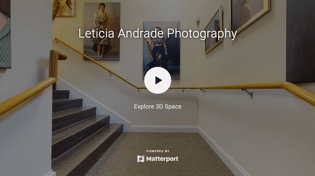 A 3d tour of a building with stairs and paintings on the wall.