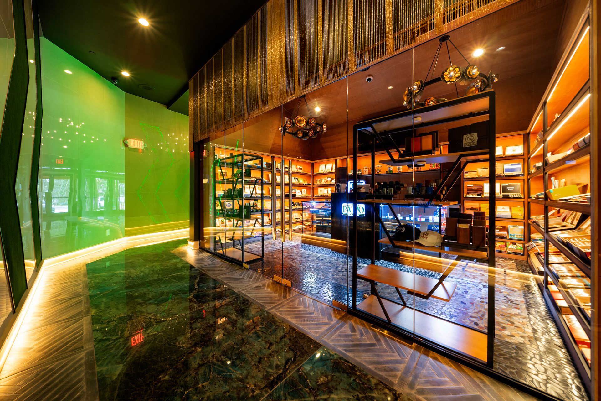 A room with a lot of shelves and a green wall.