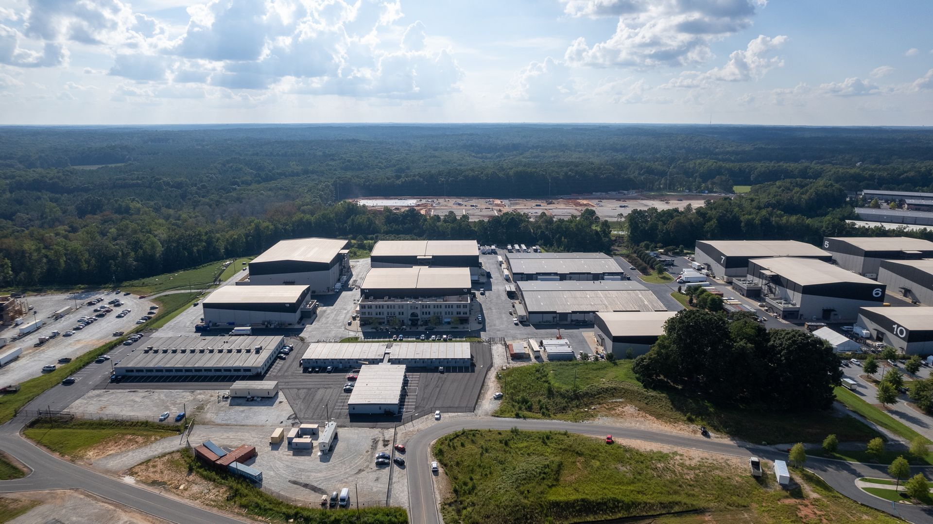 An aerial view of a large industrial area with lots of buildings and trees.