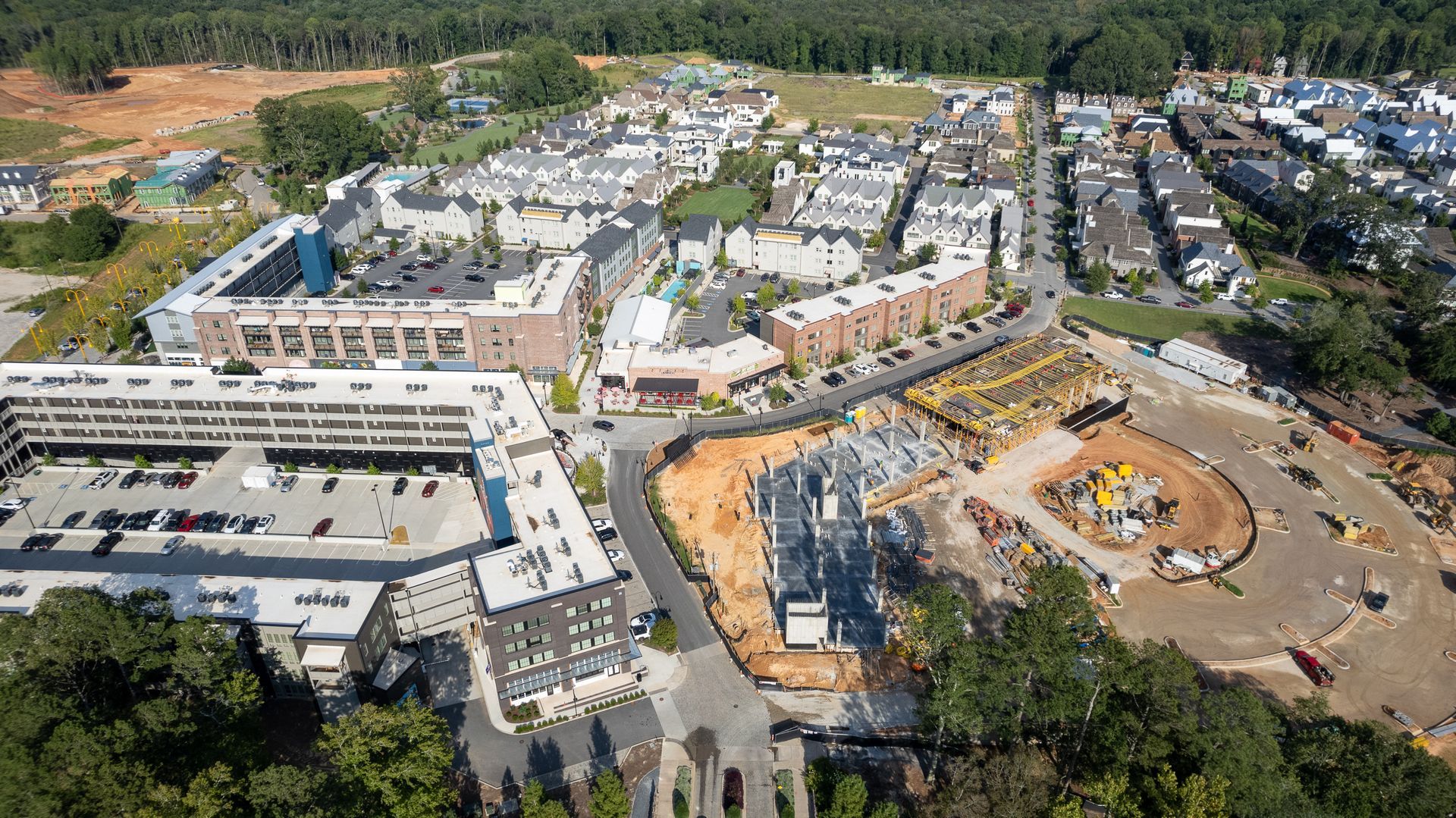 An aerial view of a city with lots of buildings and trees.